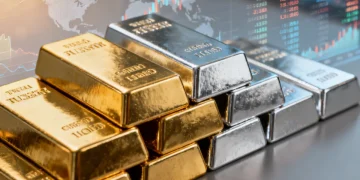 Stacked gold and silver bars with economic charts in background, symbolizing financial security.